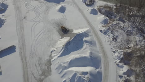 A Heavy Equipment Transporting Sand In Kingsville, Ontario, Canada On A Sunny Day - aerial shot