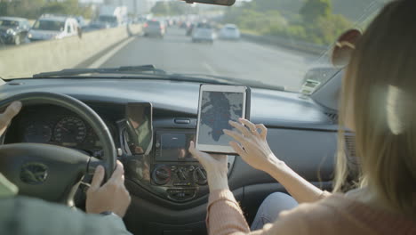 Couple using navigation app in car