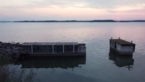 broken pier in the sea during the sunset