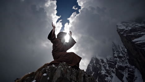 Monk in Prayer on Mountain Peak