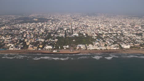 aerial footage of the entire city of puducherry and the shoreline featuring a dramatic bay of bengal