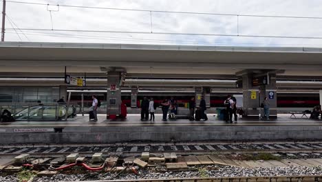 train arrives at florence station, passengers waiting