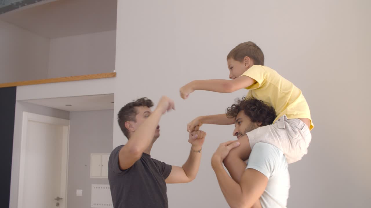Excited kid riding on dads necks