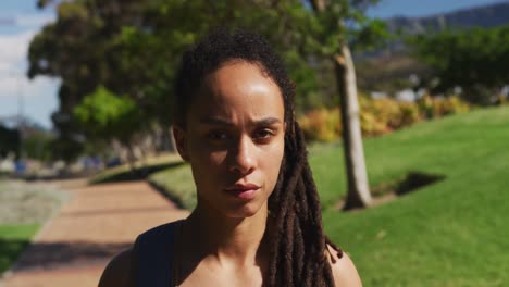 portrait of african american woman looking at camera in park