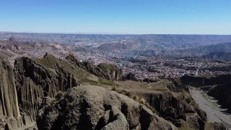 Aerial:-La-Paz,-Bolivia-seen-from-rugged-Valle-de-las-Animas-spires