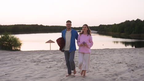 young couple leaving the lake