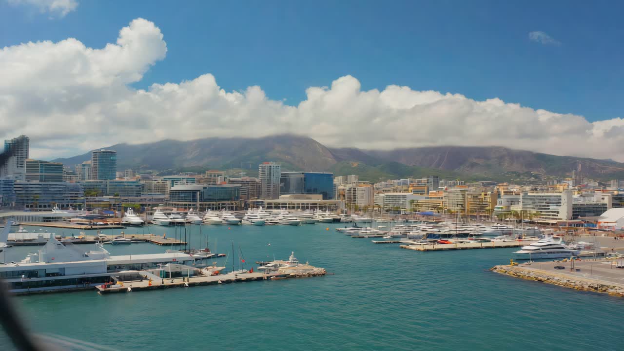 Marina with yachts and cityscape backdrop