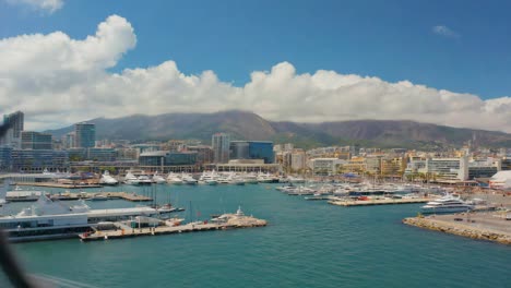 Marina with yachts and cityscape backdrop