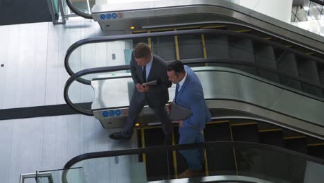 Businessmen-on-an-escalator-in-a-modern-building