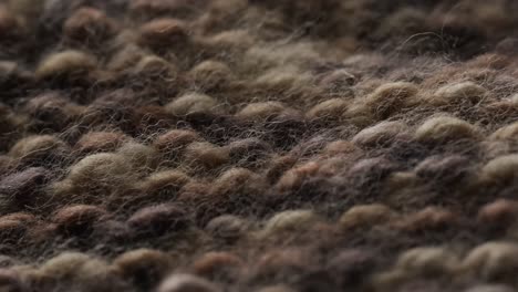 Micro-video-of-close-up-of-brown-knitted-wooly-fabric-with-copy-space