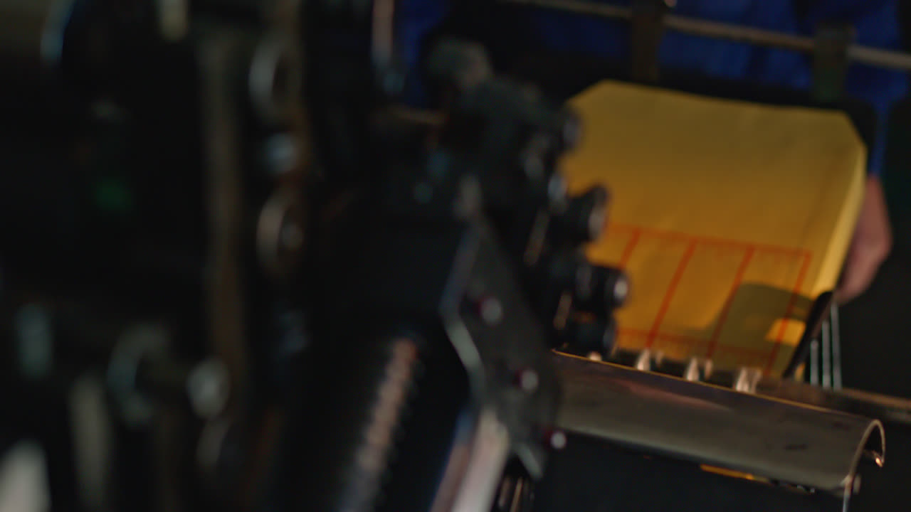 Close-Up of Hands Operating an Industrial Printing Machine