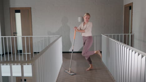 woman mopping a modern staircase