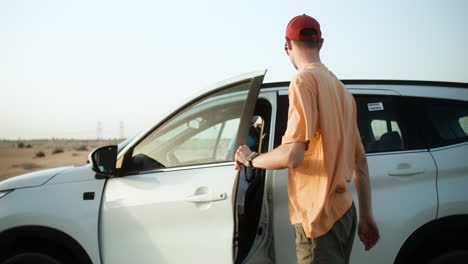 couple taking backpacks from the car