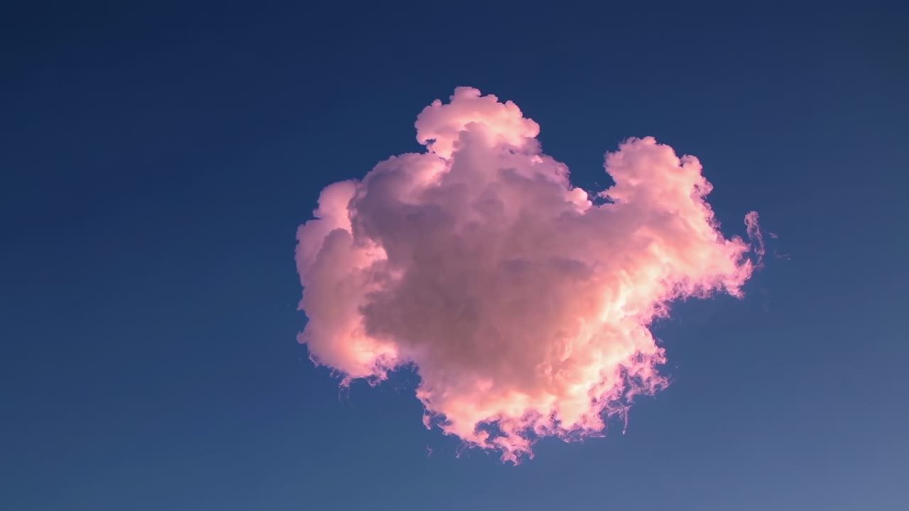 A single pink cloud floats against a clear blue sky, captured from a low angle