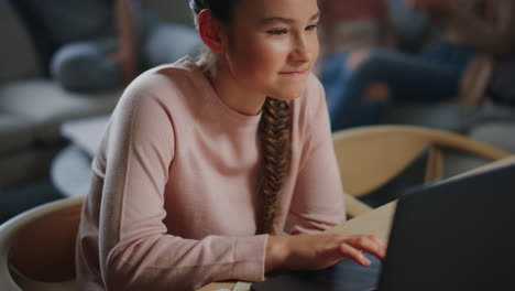 Smart-girl-learning-online-home.-Cute-schoolgirl-looking-computer-screen-indoors