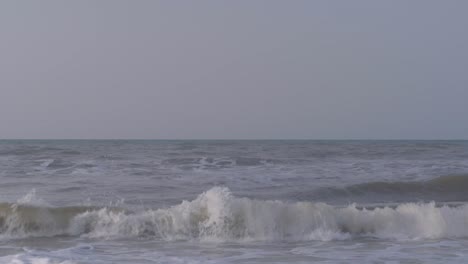 waves of the caribbean sea breaking on the sandy beach