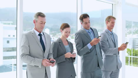business people using smartphone in office