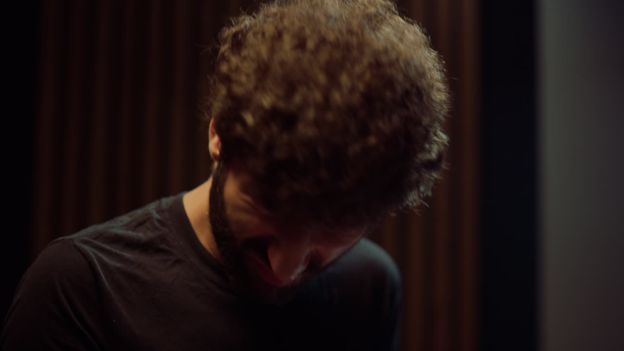 Male drummer hitting drum cymbals indoor. Musician playing drum kit in studio.