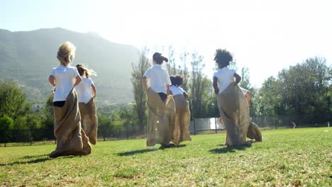 children playing a sack race in park