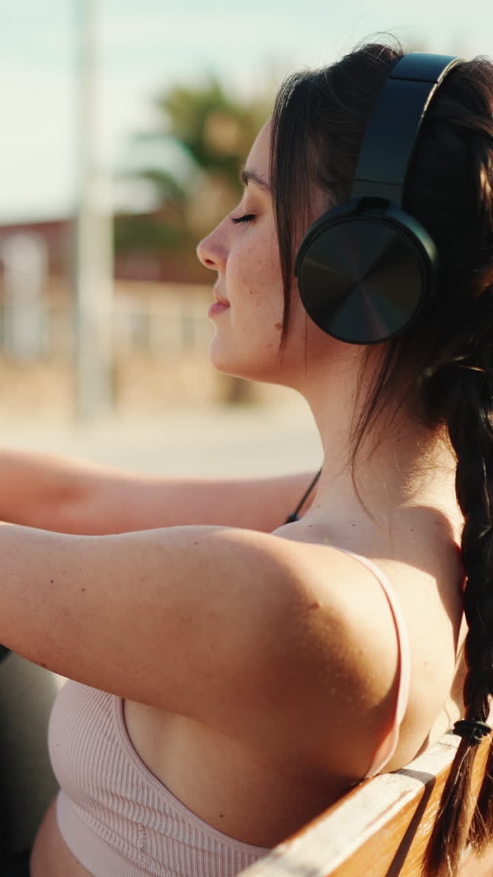 Woman enjoying music with headphones outdoors