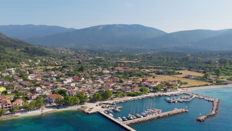 sami town and port surrounded by hills covered in pine trees, kefalonia island, aerial view
