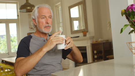 senior man having coffee on table 4k