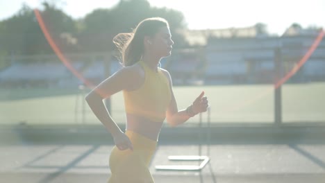 woman jogging on outdoor track in sportswear at athletic field