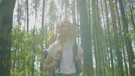 portrait of a woman walking a traveler with a backpack in a short in slow motion in the sunlight