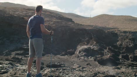 male traveler walking near blowhole