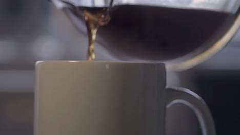 filling a cup with fresh coffee