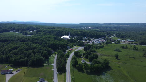aerial view of a rural town with church and highway