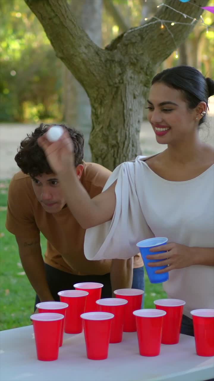 People playing beer pong outdoors