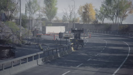road construction near a highway surrounded by autumn foliage and stillness