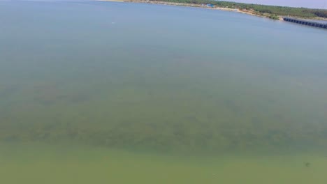 Flying-back-across-a-Salt-pen-in-south-India-with-birds-flying-around