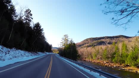 road trip from new hampshire to vermont along highway 89 snowy roadside, pov shot