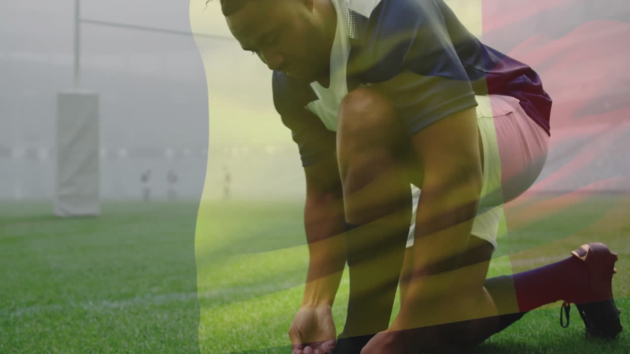 Sul campo, giocatore di rugby che si allaccia le scarpe con sovrapposizione animata dei colori della bandiera.