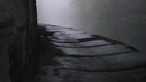 Lonely-canal-pathway-on-a-foggy-day-panning-shot