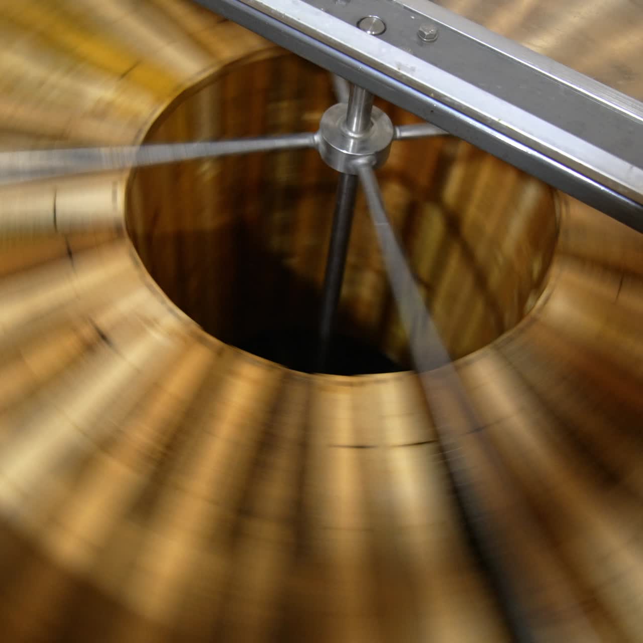 Production of healthy organic honey in the apiary. Honey extracting machine spinning the wooden frames. Top view