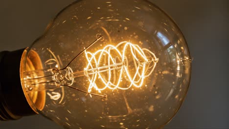 illuminating intricacies: a close-up of an antique light bulb showcasing twisted filament design, emitting a warm glow against a soft background