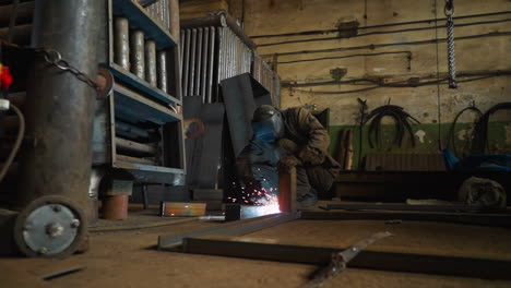 torch worker with mask connects details of beam carcass