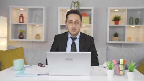 home office worker man looking at camera with fear and doubt.