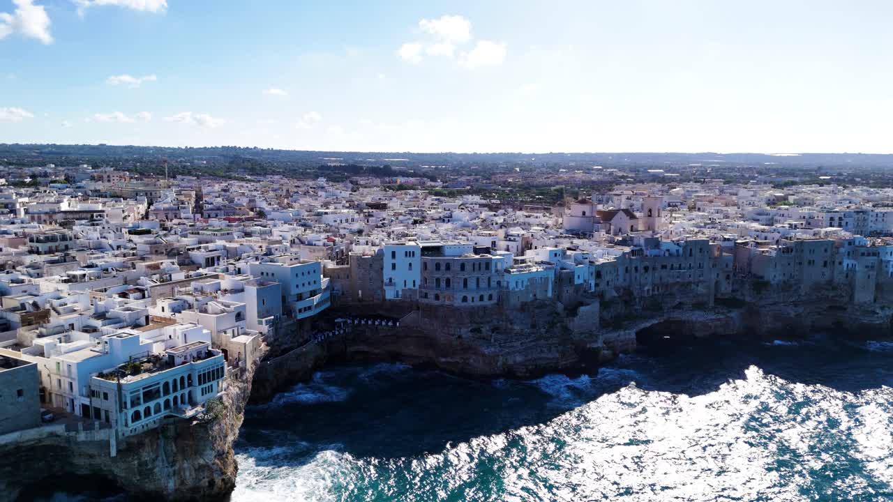 Italian township on rocky coast, aerial drone ascend view