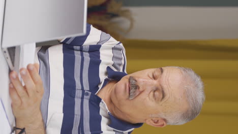 Vertical-video-of-Home-office-worker-old-man-depressed-and-unhappy.