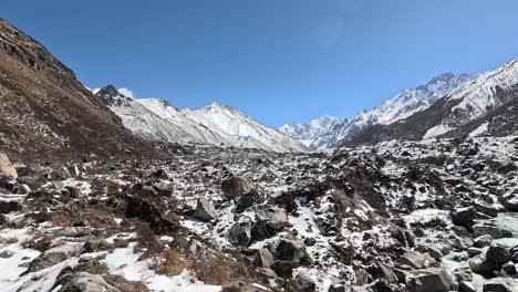 caminata alpina en el valle de langtang, nepal: viaje a través de paisajes helados con los picos de tserko ri y gangchempo en el fondo