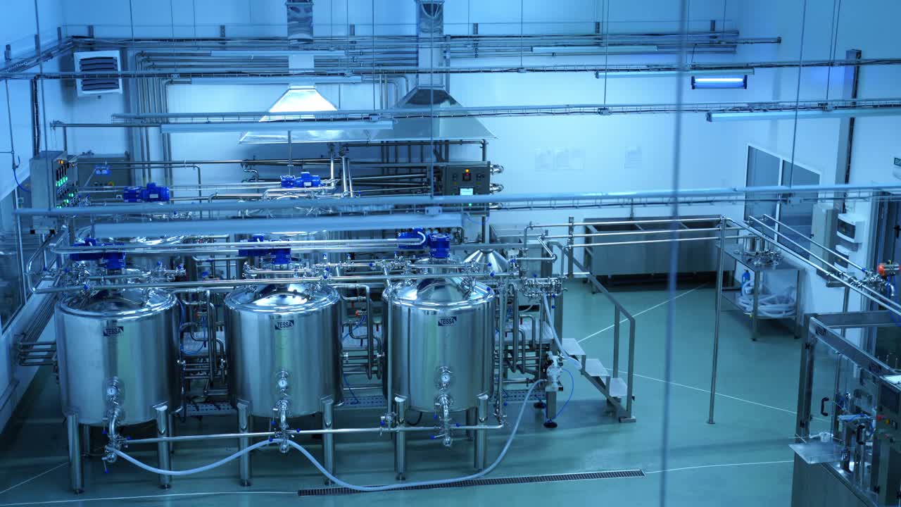 Industrial production of milk. Steel new pipelines and vats on milk factory