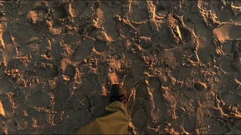 slowly walking legs hiking through the beach sand at sunrise