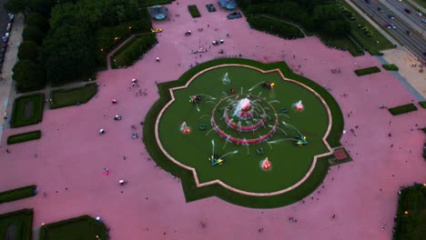 time-lapse aerial view of buckingham fountain as colorful lights dance in rhythm, capturing a magical night moment in downtown chicago’s grant park.