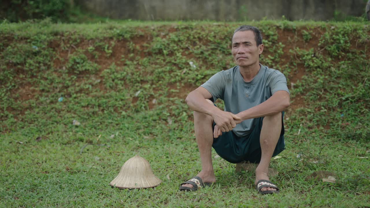 A Farmer Sitting in a Field