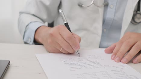 doctor writing the medical history and diagnosis on the paper