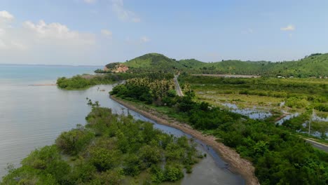 aerial view moving shot, southern shoreline and road of lombok, indonesia, scenic view of the mountain range